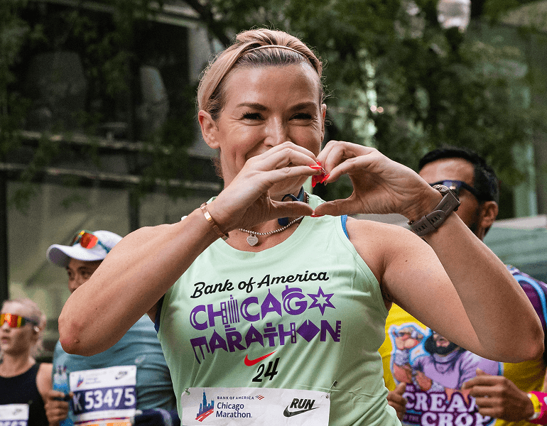 Image of a women making a heart with her hands 