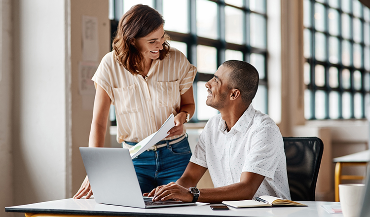 Two people looking at a computer