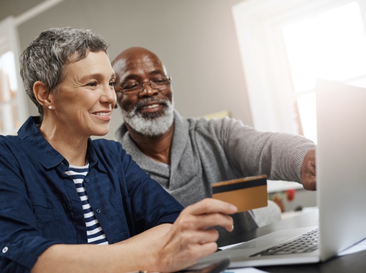 Man and woman smiling at computer