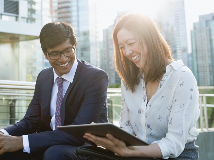 Woman and man smiling with tablet