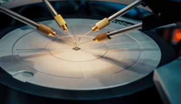 An electronic chip being checked using a probe station