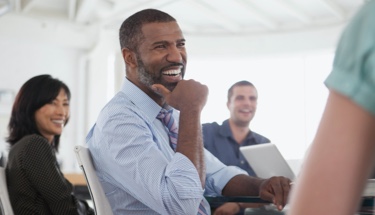 Self-assured man reacting to public speaker at event