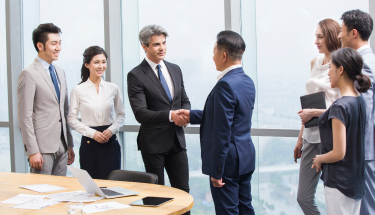 A group of people having a business meeting and shaking hands