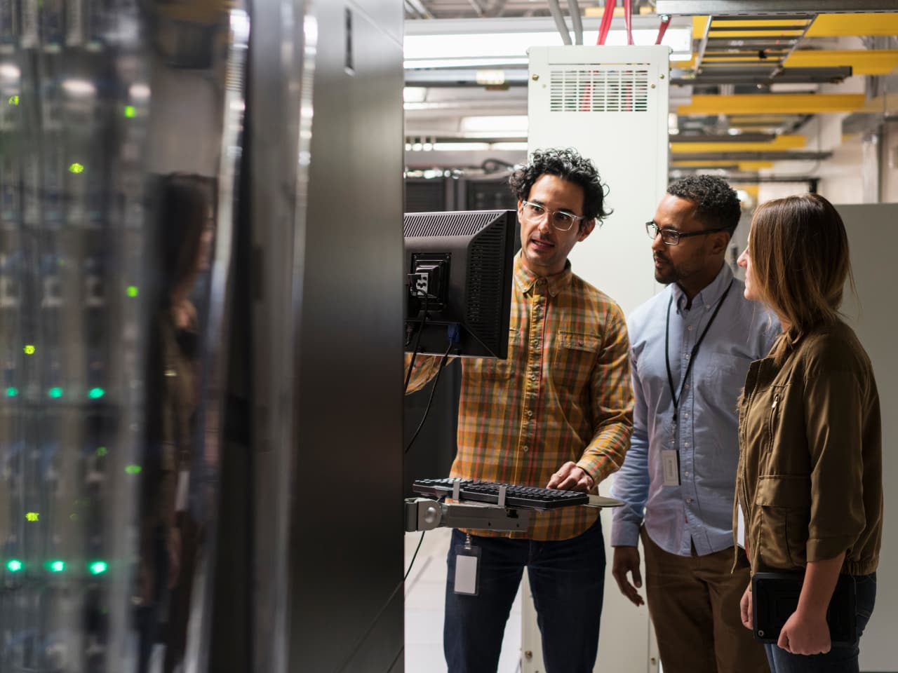 3 people in a server room