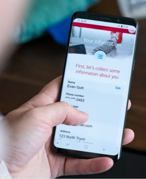 Person holding cellphone showing their Bank of America app