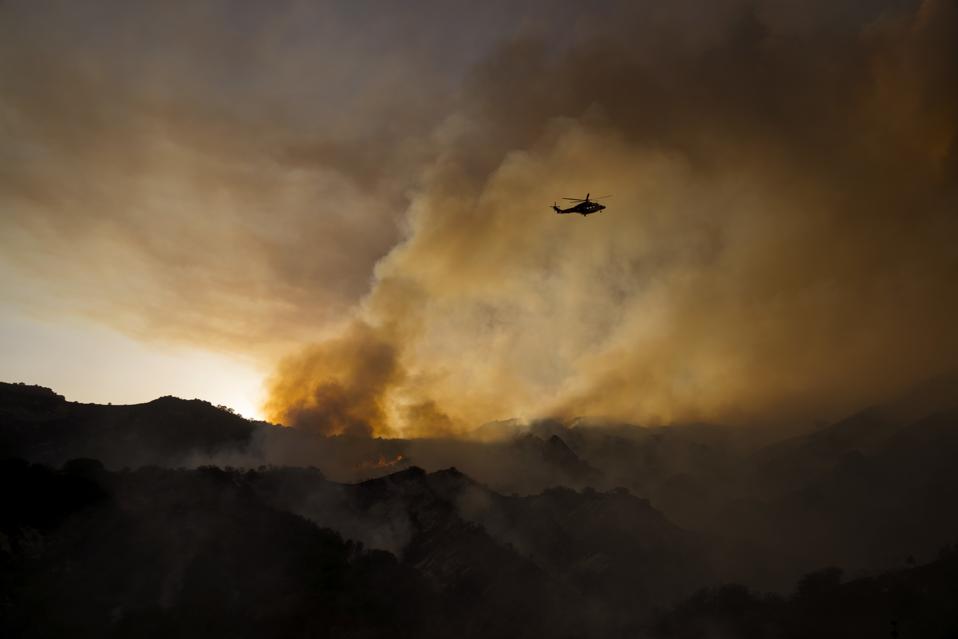 A Helicopter Fighting A Wildfire