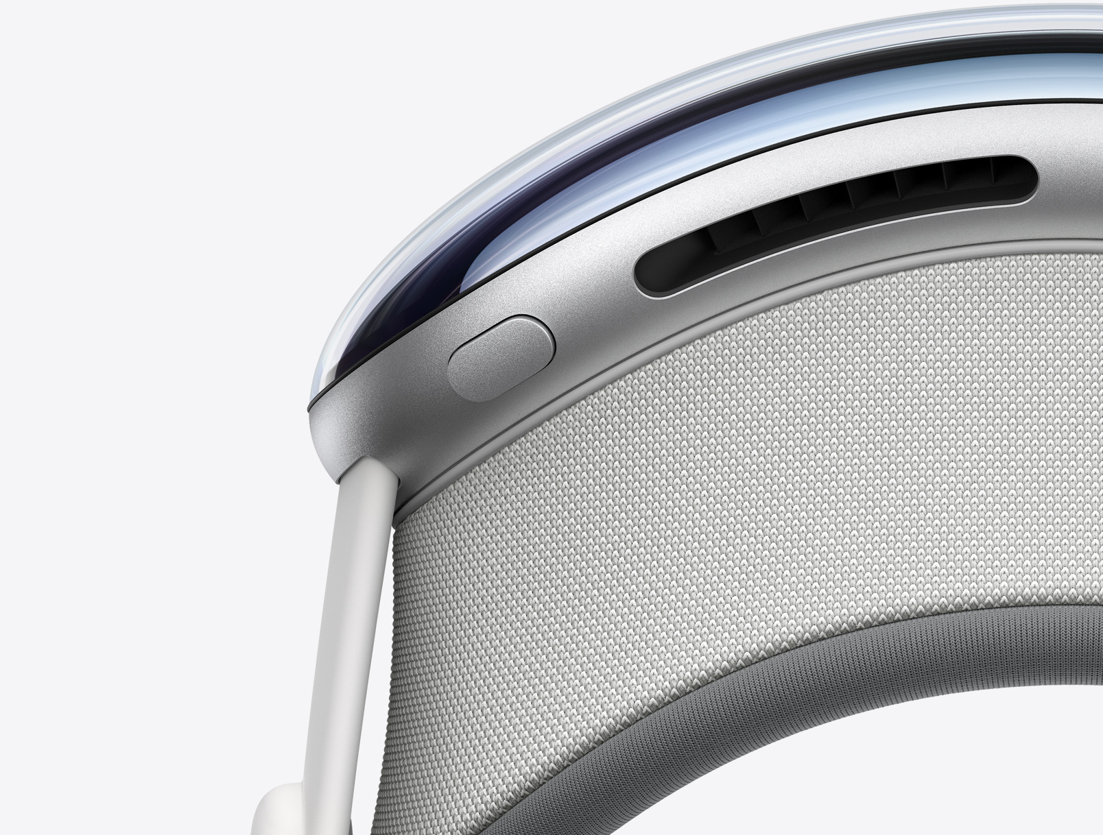 Vue de biais d’Apple Vision Pro placé à la verticale montrant le bouton supérieur