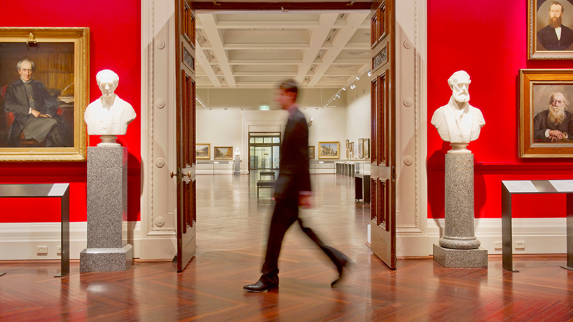 A visitor walking through a museum